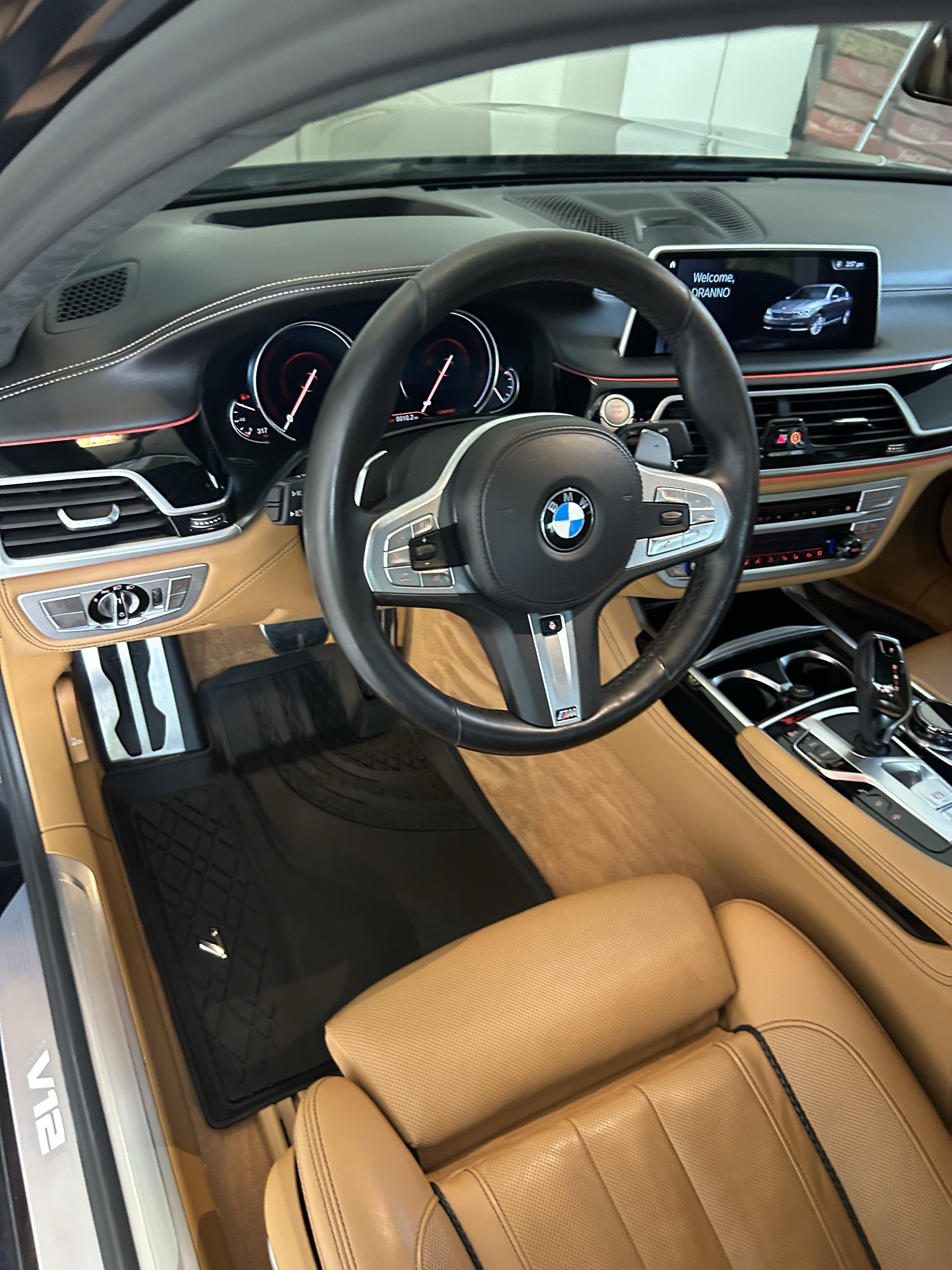 Freshly detailed BMW interior with tan leather and V12 badge