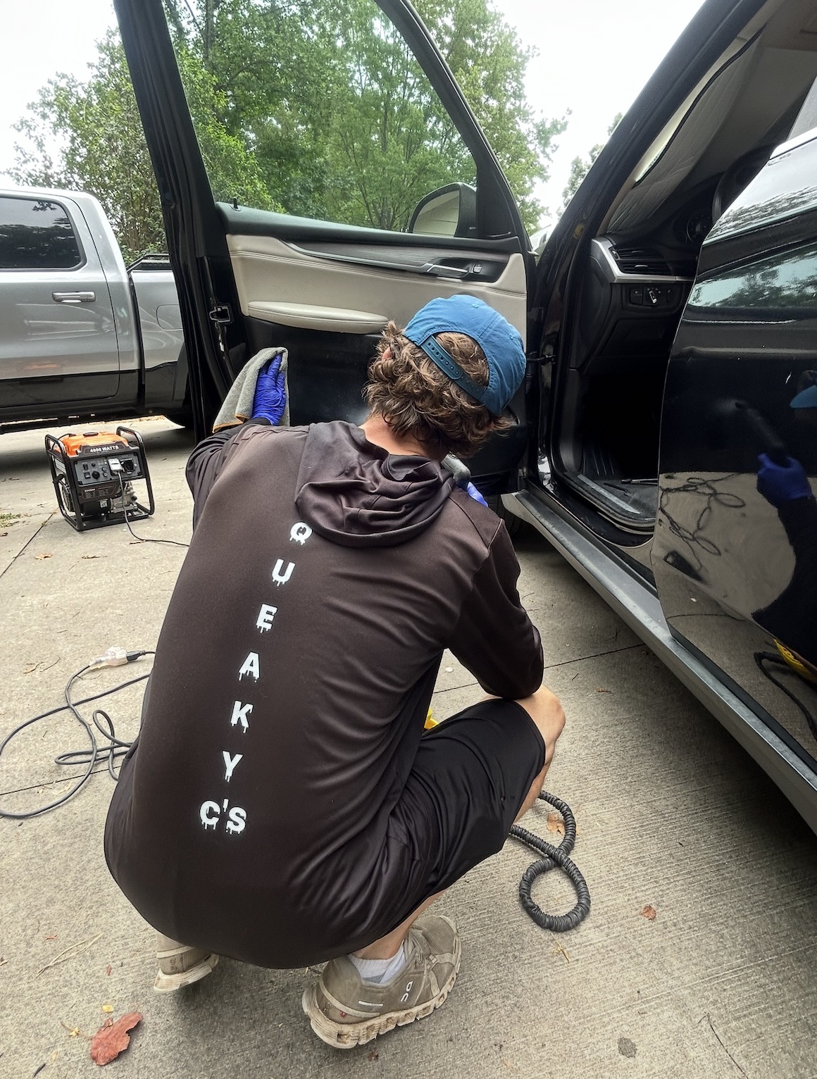 Squeaky C's technician detailing a vehicle interior door panel