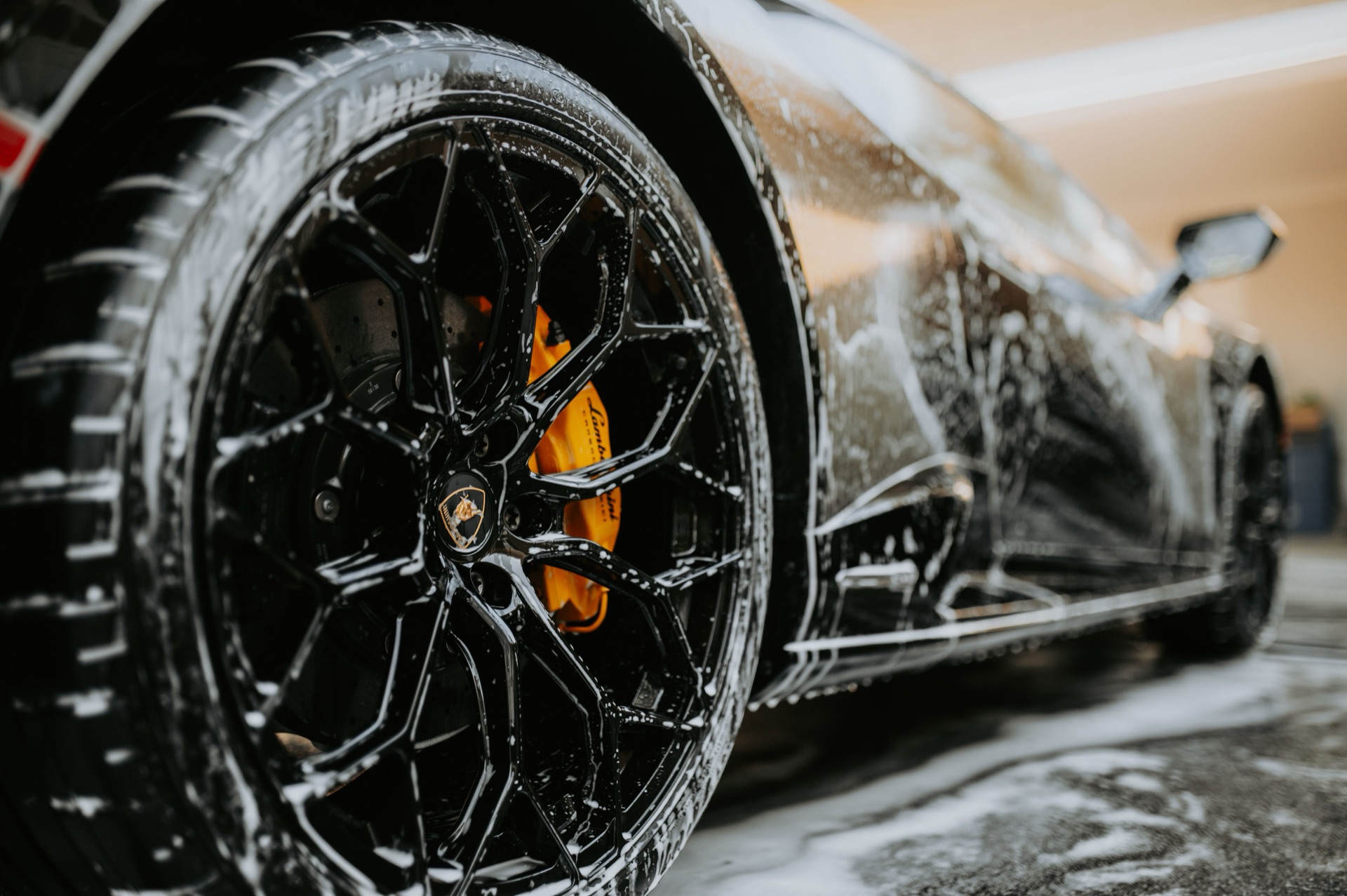 Foam wash on a detailed sports car wheel and body